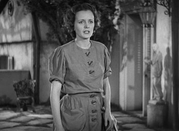 Movie still from “Dodsworth” (1936), directed by William Wyler – An old photo of a woman standing in front of a building; Medium shot, Low angle