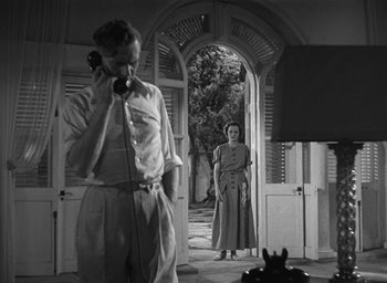Movie still from “Dodsworth” (1936), directed by William Wyler – A man and a woman standing in front of an arched doorway; Wide shot, Low angle
