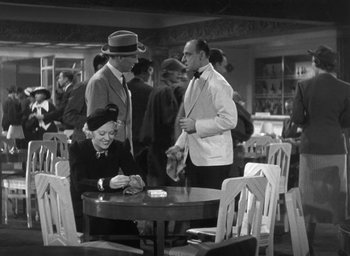 Movie still from “Dodsworth” (1936), directed by William Wyler – An old black and white photo of people at a table; Wide shot, High angle