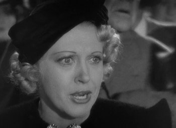 Movie still from “Dodsworth” (1936), directed by William Wyler – An old photo of a woman in a black hat; Close Up shot, High angle