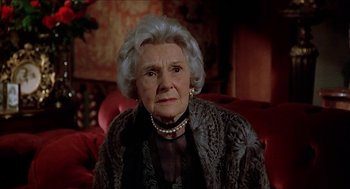 Movie still from “Family Plot” (1976), directed by Alfred Hitchcock – An older woman wearing a black dress and a black jacket; Close Up shot, Low angle