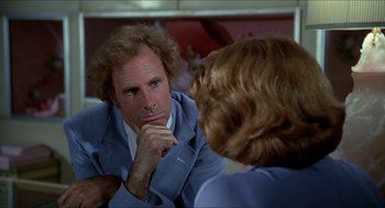 Movie still from “Family Plot” (1976), directed by Alfred Hitchcock – A man sitting in front of a mirror looking at himself in the mirror; Close Up shot, Over the shoulder angle