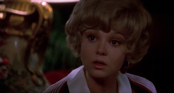 Movie still from “Family Plot” (1976), directed by Alfred Hitchcock – A person with short blonde hair; Close Up shot, Over the shoulder angle