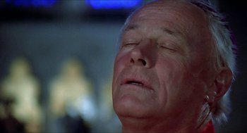 Movie still from “Family Plot” (1976), directed by Alfred Hitchcock – An older man with his eyes closed and his head down; Extreme Close Up shot, Low angle