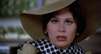 Movie still from “Family Plot” (1976), directed by Alfred Hitchcock – A person wearing a hat; Close Up shot, Low angle
