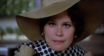 Movie still from “Family Plot” (1976), directed by Alfred Hitchcock – A person wearing a hat; Close Up shot, Low angle
