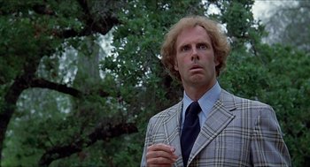 Movie still from “Family Plot” (1976), directed by Alfred Hitchcock – A man in a plaid jacket and a blue tie; Close Up shot, Low angle