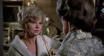 Movie still from “Family Plot” (1976), directed by Alfred Hitchcock – A woman is looking at a man in a mirror; Close Up shot, Over the shoulder angle
