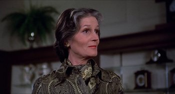 Movie still from “Family Plot” (1976), directed by Alfred Hitchcock – An older woman in a patterned jacket looking to her left; Close Up shot, Low angle