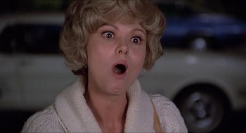 Movie still from “Family Plot” (1976), directed by Alfred Hitchcock – A person with her mouth wide open; Close Up shot, Low angle
