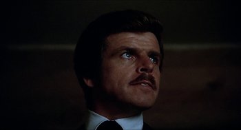 Movie still from “Family Plot” (1976), directed by Alfred Hitchcock – A man that is looking up at the sky; Close Up shot, Low angle