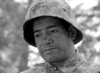 Movie still from “Fear and Desire” (1952), directed by Stanley Kubrick – Black and white photograph of a man in a military uniform; Close Up shot, Low angle