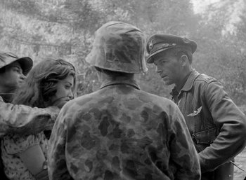Movie still from “Fear and Desire” (1952), directed by Stanley Kubrick – A group of people standing next to each other; Medium shot, Over the shoulder angle