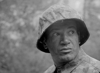 Movie still from “Fear and Desire” (1952), directed by Stanley Kubrick – Black and white photograph of a man wearing a hat; Close Up shot, Low angle