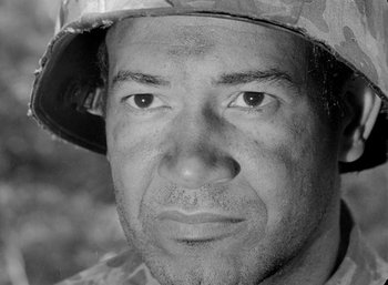 Movie still from “Fear and Desire” (1952), directed by Stanley Kubrick – Black and white photograph of a man wearing a hat; Close Up shot, Low angle