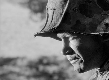 Movie still from “Fear and Desire” (1952), directed by Stanley Kubrick – A person wearing a helmet; Close Up shot, Low angle