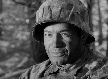 Movie still from “Fear and Desire” (1952), directed by Stanley Kubrick – Black and white photograph of a man in a military uniform; Close Up shot, Low angle