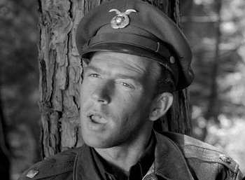 Movie still from “Fear and Desire” (1952), directed by Stanley Kubrick – A man wearing a military uniform and a hat; Close Up shot, Low angle