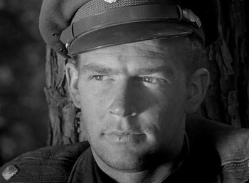 Movie still from “Fear and Desire” (1952), directed by Stanley Kubrick – Black and white photograph of a man wearing a hat; Close Up shot, Low angle