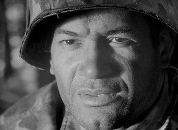 Movie still from “Fear and Desire” (1952), directed by Stanley Kubrick – A black and white photo of a man wearing a helmet; Close Up shot, Low angle