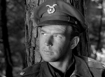 Movie still from “Fear and Desire” (1952), directed by Stanley Kubrick – A man wearing a military uniform and a hat; Close Up shot, Low angle