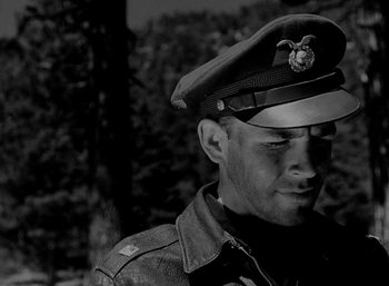 Movie still from “Fear and Desire” (1952), directed by Stanley Kubrick – A man in a military uniform wearing a hat; Close Up shot, Low angle
