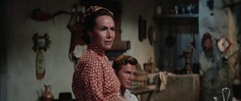 Movie still from “Flaming Star” (1960), directed by Don Siegel – A man and a woman standing next to each other in a room; Close Up shot, Over the shoulder angle