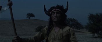Movie still from “Flaming Star” (1960), directed by Don Siegel – A man in a native american costume with horns; Medium shot, Low angle