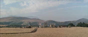 Movie still from “Flaming Star” (1960), directed by Don Siegel – A dirt road in the middle of a desert; Extreme Wide shot, High angle