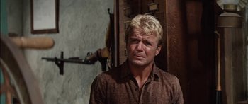 Movie still from “Flaming Star” (1960), directed by Don Siegel – A man with blonde hair and a brown shirt; Close Up shot, Low angle
