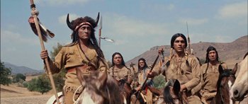 Movie still from “Flaming Star” (1960), directed by Don Siegel – A group of native americans on horseback in the desert; Medium shot, Low angle