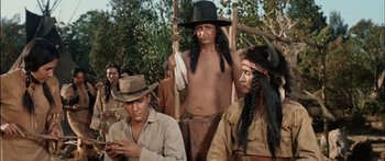 Movie still from “Flaming Star” (1960), directed by Don Siegel – An old photo of a man with a long hair and a hat; Medium shot, Over the shoulder angle