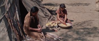 Movie still from “Flaming Star” (1960), directed by Don Siegel – Two native american girls making corn on the cob; Medium shot, High angle