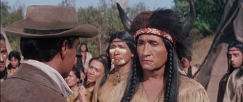 Movie still from “Flaming Star” (1960), directed by Don Siegel – A group of native american men standing next to each other; Close Up shot, Over the shoulder angle