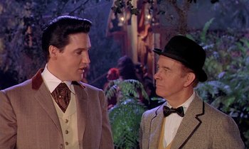 Movie still from “Frankie and Johnny” (1966), directed by Frederick De Cordova – A man and a man in a suit and hat; Medium shot, Over the shoulder angle