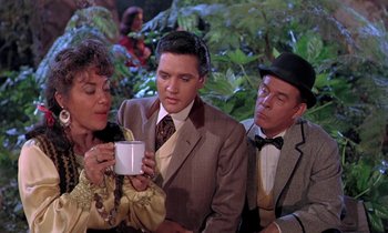 Movie still from “Frankie and Johnny” (1966), directed by Frederick De Cordova – A man and two women are holding a cup; Medium shot, Over the shoulder angle