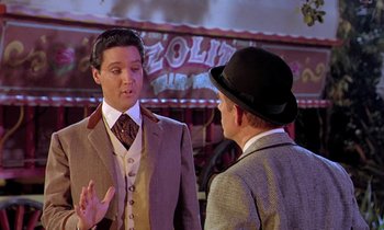 Movie still from “Frankie and Johnny” (1966), directed by Frederick De Cordova – A man in a suit and hat talking to another man in a suit and hat; Medium shot, Over the shoulder angle