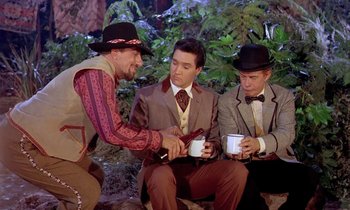 Movie still from “Frankie and Johnny” (1966), directed by Frederick De Cordova – A group of men sitting next to each other holding coffee cups; Medium shot, Over the shoulder angle
