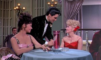 Movie still from “Frankie and Johnny” (1966), directed by Frederick De Cordova – A man and two women sitting at a table; Medium shot, Low angle