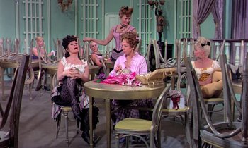Movie still from “Frankie and Johnny” (1966), directed by Frederick De Cordova – A group of women sitting at a table in front of a window; Wide shot, High angle
