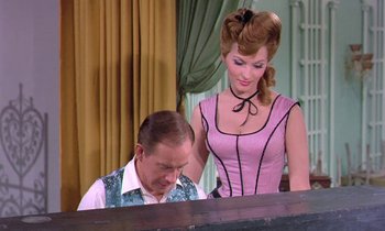 Movie still from “Frankie and Johnny” (1966), directed by Frederick De Cordova – A man and a woman are playing a piano together; Medium shot, Over the shoulder angle