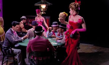 Movie still from “Frankie and Johnny” (1966), directed by Frederick De Cordova – A group of people sitting at a table playing a game; Wide shot, High angle