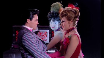 Movie still from “Frankie and Johnny” (1966), directed by Frederick De Cordova – A man and two women are sitting in front of a computer; Medium shot, Over the shoulder angle