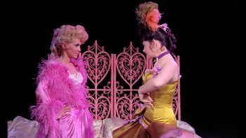 Movie still from “Frankie and Johnny” (1966), directed by Frederick De Cordova – A couple of women standing next to each other on top of a bed; Medium shot, High angle