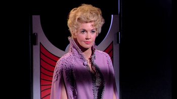 Movie still from “Frankie and Johnny” (1966), directed by Frederick De Cordova – A woman with blonde hair wearing a purple dress; Medium shot, Low angle