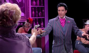 Movie still from “Frankie and Johnny” (1966), directed by Frederick De Cordova – A man in a purple striped jacket holding a gun; Medium shot, Over the shoulder angle