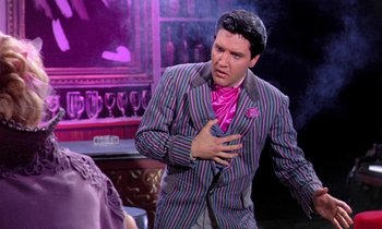 Movie still from “Frankie and Johnny” (1966), directed by Frederick De Cordova – A man in a striped suit and a pink tie; Medium shot, Over the shoulder angle