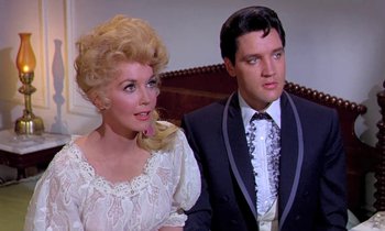 Movie still from “Frankie and Johnny” (1966), directed by Frederick De Cordova – A man and a woman standing next to each other; Close Up shot, Low angle