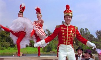 Movie still from “Frankie and Johnny” (1966), directed by Frederick De Cordova – A group of people dressed in red and white costumes; Wide shot, Low angle