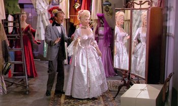 Movie still from “Frankie and Johnny” (1966), directed by Frederick De Cordova – A man standing next to a woman wearing a dress; Wide shot, Over the shoulder angle